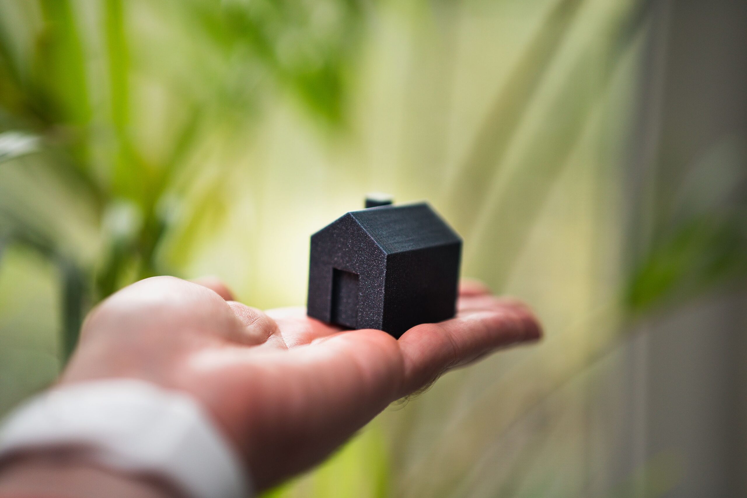 A hand holding a small house representing security and trust in the 5P insurance growth framework.